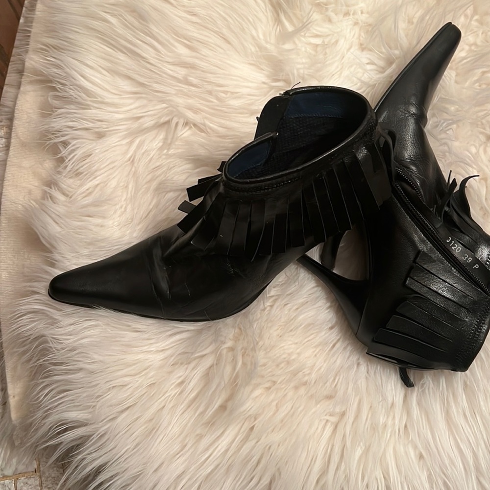COPY - Black leather stiletto boots with the fringes zips up on the side .